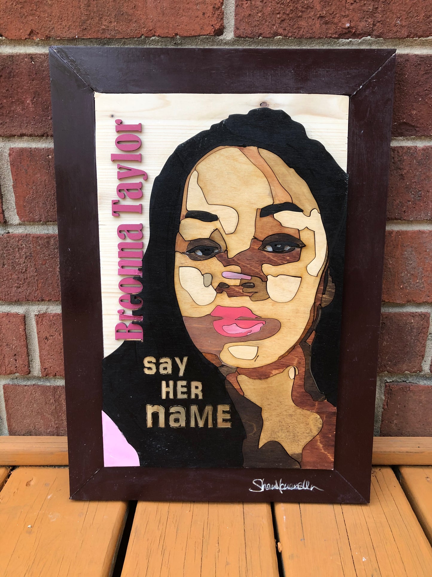Woodcut of Breonna Taylor with a woodcut printed of her name along with engraved, "Say Her Name"
